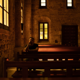 young man sitting alone in church