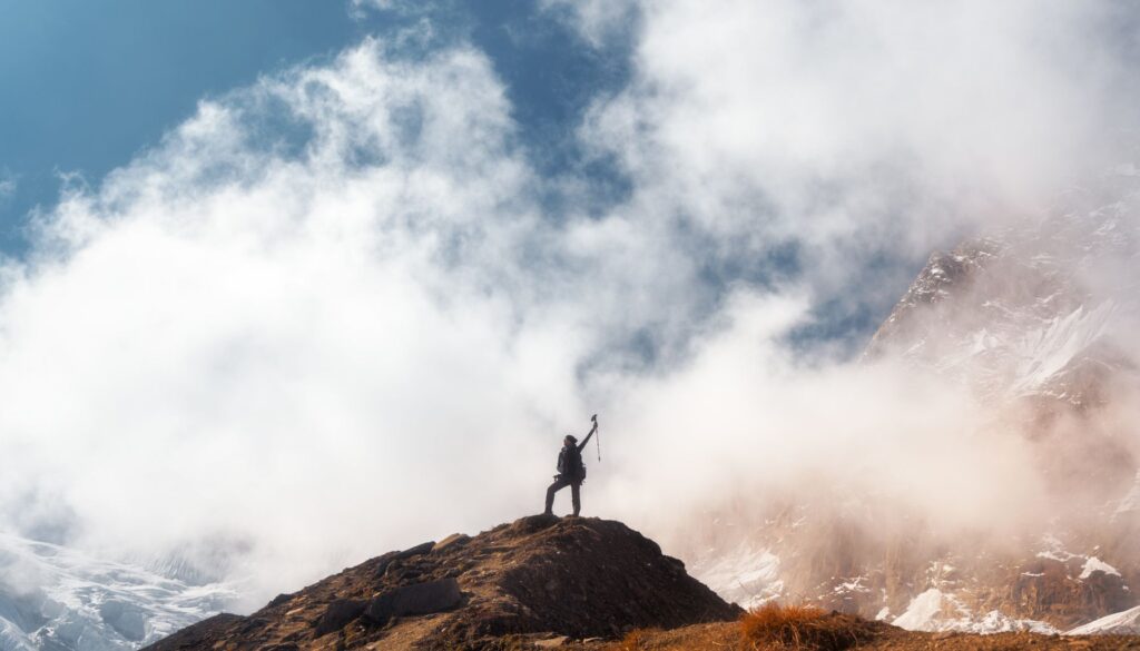 Young woman on top of a mountain celebrating