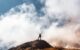 Young woman on top of a mountain celebrating